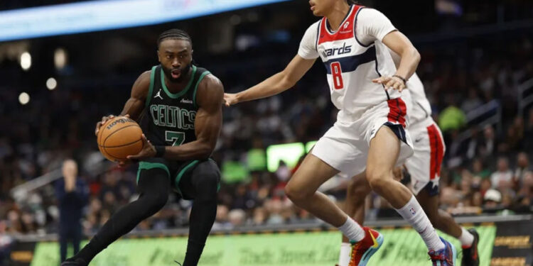 Oct 24, 2024; Washington, District of Columbia, USA; Boston Celtics guard Jaylen Brown (7) drives to the basket as Washington Wizards forward Kyshawn George (18) defends in the first half at Capital One Arena. Mandatory Credit: Geoff Burke-Imagn Images