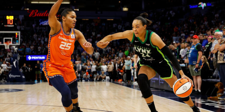 MINNEAPOLIS, MINNESOTA - OCTOBER 01: Napheesa Collier #24 of the Minnesota Lynx drives to the basket against Alyssa Thomas #25 of the Connecticut Sun in the first quarter of Game Two of the Semi-Finals during the WNBA Playoffs at Target Center on October 01, 2024 in Minneapolis, Minnesota. NOTE TO USER: User expressly acknowledges and agrees that, by downloading and or using this photograph, User is consenting to the terms and conditions of the Getty Images License Agreement. (Photo by David Berding/Getty Images)