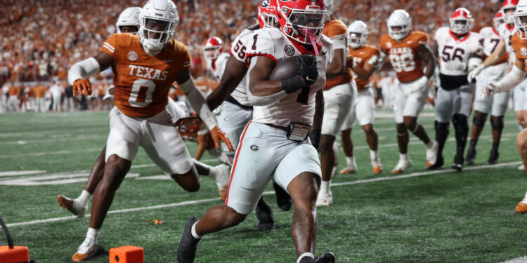 AUSTIN, TX - OCTOBER 19: Georgia Bulldogs running back Trevor Etienne (1) runs runs to the corner of the end zone for a touchdown during the SEC college football game between Texas Longhorns and Georgia Bulldogs on October 19, 2024, at Darrell K Royal - Texas Memorial Stadium in Austin, TX.  (Photo by David Buono/Icon Sportswire via Getty Images)