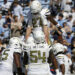 Georgia Tech running back Chad Alexander (27) is hoisted up by his teammates after he scored a touchdown during the first half of an NCAA college football game against North Carolina, Saturday, Oct. 12, 2024, in Chapel Hill, N.C. (AP Photo/Chris Seward)