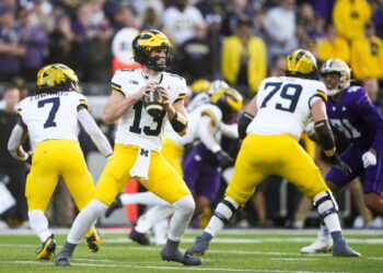 Michigan quarterback Jack Tuttle (13) looks to pass against Washington during the first half of an NCAA college football game Saturday, Oct. 5, 2024, in Seattle. (AP Photo/Lindsey Wasson)