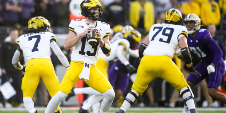 Michigan quarterback Jack Tuttle (13) looks to pass against Washington during the first half of an NCAA college football game Saturday, Oct. 5, 2024, in Seattle. (AP Photo/Lindsey Wasson)