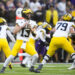 Michigan quarterback Jack Tuttle (13) looks to pass against Washington during the first half of an NCAA college football game Saturday, Oct. 5, 2024, in Seattle. (AP Photo/Lindsey Wasson)