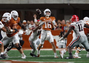 AUSTIN, TX - OCTOBER 19: Georgia Bulldogs linebacker Jalon Walker (11) forces a fumble on Texas Longhorns quarterback Arch Manning (16) during the SEC college football game between Texas Longhorns and Georgia Bulldogs on October 19, 2024, at Darrell K Royal - Texas Memorial Stadium in Austin, TX.  (Photo by David Buono/Icon Sportswire via Getty Images)