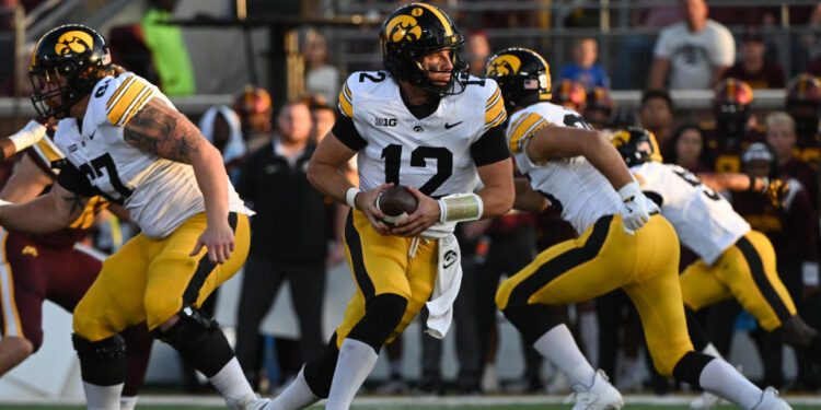 MINNEAPOLIS, MN - SEPTEMBER 21: Iowa Hawkeyes QB Cade McNamara (12) drops back to pass during game between the Iowa Hawkeyes and the Minnesota Golden Gophers on September 21, 2024, at Huntington Bank Stadium in Minneapolis, MN. (Photo by John Rivera/Icon Sportswire via Getty Images)