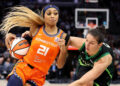 Oct 1, 2024; Minneapolis, Minnesota, USA; Connecticut Sun guard DiJonai Carrington (21) works around Minnesota Lynx forward Cecilia Zandalasini (9) during the second half of game two of the 2024 WNBA Semi-finals at Target Center. Mandatory Credit: Matt Krohn-Imagn Images     TPX IMAGES OF THE DAY