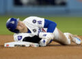 Los Angeles Dodgers' Shohei Ohtani holds his arm after being injured while trying to steal second base during the seventh inning in Game 2 of the baseball World Series against the New York Yankees, Saturday, Oct. 26, 2024, in Los Angeles. (AP Photo/Godofredo A. Vásquez)