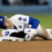 Los Angeles Dodgers' Shohei Ohtani holds his arm after being injured while trying to steal second base during the seventh inning in Game 2 of the baseball World Series against the New York Yankees, Saturday, Oct. 26, 2024, in Los Angeles. (AP Photo/Godofredo A. Vásquez)