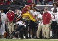 USC receiver Kyle Ford leaps over Rutgers defensive back Flip Dixon during the Trojans' win Friday night at the Coliseum