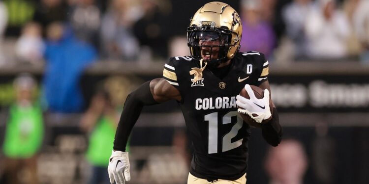 Travis Hunter running with ball