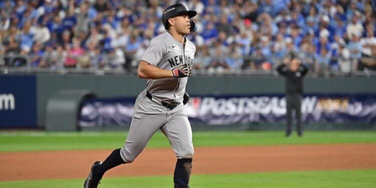 Oct 9, 2024; Kansas City, Missouri, USA; New York Yankees designated hitter Giancarlo Stanton (27) runs the bases after hitting a home run in the eighth inning against the Kansas City Royals during game three of the NLDS for the 2024 MLB Playoffs at Kauffman Stadium. Mandatory Credit: Peter Aiken-Imagn Images