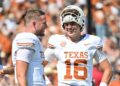 DALLAS, TEXAS - OCTOBER 12: Arch Manning #16 and Quinn Ewers #3 of the Texas Longhorns talk on the field before a game O at Cotton Bowl Stadium on October 12, 2024 in Dallas, Texas. (Photo by Sam Hodde/Getty Images)