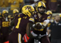 Minnesota quarterback Max Brosmer, right, hands the ball off to running back Darius Taylor (1) during the first half of an NCAA college football game against Southern California, Saturday, Oct. 5, 2024, in Minneapolis. (AP Photo/Ellen Schmidt)