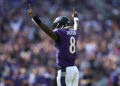 Lamar Jackson #8 of the Baltimore Ravens celebrates after teammate Derrick Henry #22 scores a touchdown against the Washington Commanders during the second quarter at M&T Bank Stadium on October 13, 2024 in Baltimore, Maryland. (Photo by Patrick Smith/Getty Images)