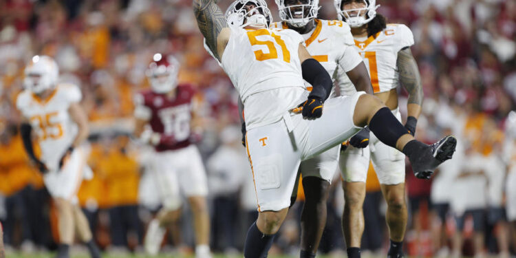 NORMAN, OKLAHOMA - SEPTEMBER 21:  Defensive lineman Jaxson Moi #51 of the Tennessee Volunteers celebrates his sack against the Oklahoma Sooners with defensive back Christian Harrison #5 and linebacker Keenan Pili #11 in the fourth quarter at Gaylord Family Oklahoma Memorial Stadium on September 21, 2024 in Norman, Oklahoma.   Tennessee won 25-15. (Photo by Brian Bahr/Getty Images)