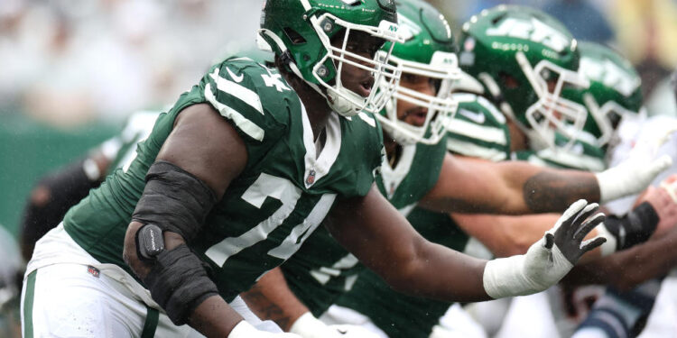 EAST RUTHERFORD, NEW JERSEY - SEPTEMBER 29: Olu Fashanu #74 of the New York Jets in action against the Denver Broncos at MetLife Stadium on September 29, 2024 in East Rutherford, New Jersey. (Photo by Luke Hales/Getty Images)