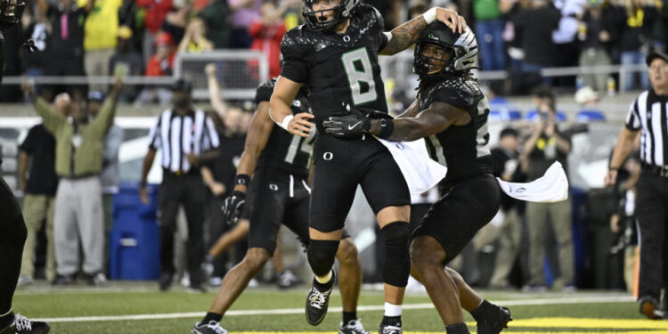 Oregon Ducks quarterback Dillon Gabriel celebrates after a touchdown on Saturday. (Troy Wayrynen-Imagn Images)