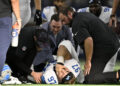 Detroit Lions defensive end Aidan Hutchinson (97) is attended to by team staff after suffering an unknown injury second half of an NFL football game against the Dallas Cowboys in Arlington, Texas, Sunday, Oct. 13, 2024. (AP Photo/Jerome Miron)