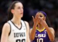 Angel Reese of the LSU Lady Tigers reacts towards Caitlin Clark