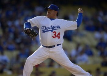 Fernando Valenzuela throws to the plate during the Old-Timers baseball game, June 8, 2013, in Los Angeles. Fernando Valenzuela, the Mexican-born phenom for the Los Angeles Dodgers who inspired “Fernandomania” while winning the NL Cy Young Award and Rookie of the Year in 1981, has died Tuesday, Oct. 22, 2024. (AP Photo/Mark J. Terrill, File)