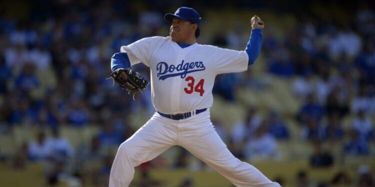 Fernando Valenzuela throws to the plate during the Old-Timers baseball game, June 8, 2013, in Los Angeles. Fernando Valenzuela, the Mexican-born phenom for the Los Angeles Dodgers who inspired “Fernandomania” while winning the NL Cy Young Award and Rookie of the Year in 1981, has died Tuesday, Oct. 22, 2024. (AP Photo/Mark J. Terrill, File)