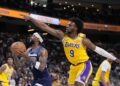 Minnesota Timberwolves guard Nickeil Alexander-Walker, center, shoots as Los Angeles Lakers.