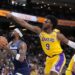 Minnesota Timberwolves guard Nickeil Alexander-Walker, center, shoots as Los Angeles Lakers.