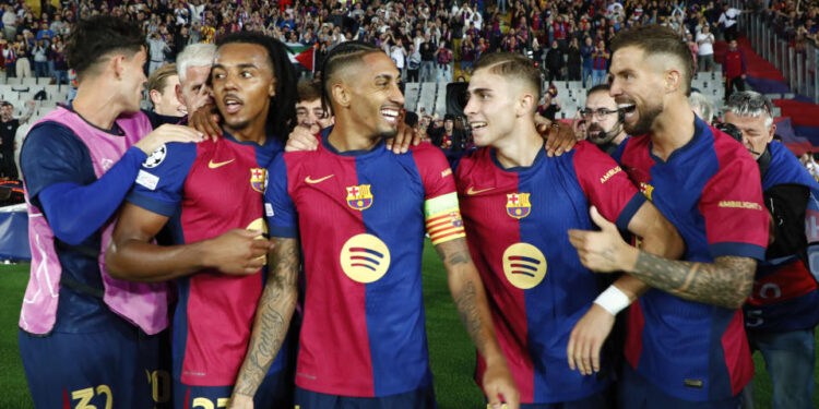 Barcelona's Raphinha, centre, celebrates with teammates after scoring his sides forth goal during a Champions League opening phase soccer match between Barcelona and Bayern Munich at the Lluis Companys Olympic Stadium in Barcelona, Spain, Wednesday, Oct. 23, 2024. (AP Photo/Joan Monfort)