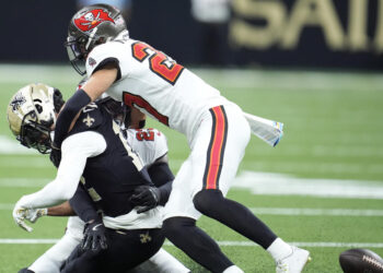 Chris Olave left Sunday's game with a concussion after this hit by Zyon McCollum. (AP Photo/Michael Conroy)