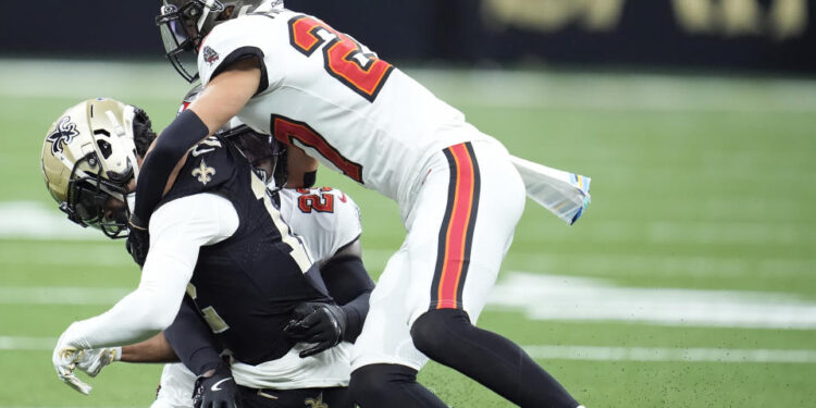 Chris Olave left Sunday's game with a concussion after this hit by Zyon McCollum. (AP Photo/Michael Conroy)