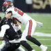 Chris Olave left Sunday's game with a concussion after this hit by Zyon McCollum. (AP Photo/Michael Conroy)