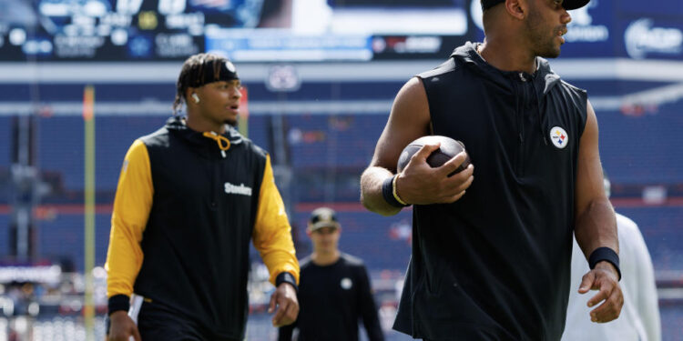 DENVER, CO - SEPTEMBER 15: Quarterback Justin Fields #2 of the Pittsburgh Steelers and quarterback Russell Wilson #3 stand on the field prior to an NFL football game against the Denver Broncos, at Empower Field at Mile High on September 15, 2024 in Denver, Colorado. (Photo by Brooke Sutton/Getty Images)