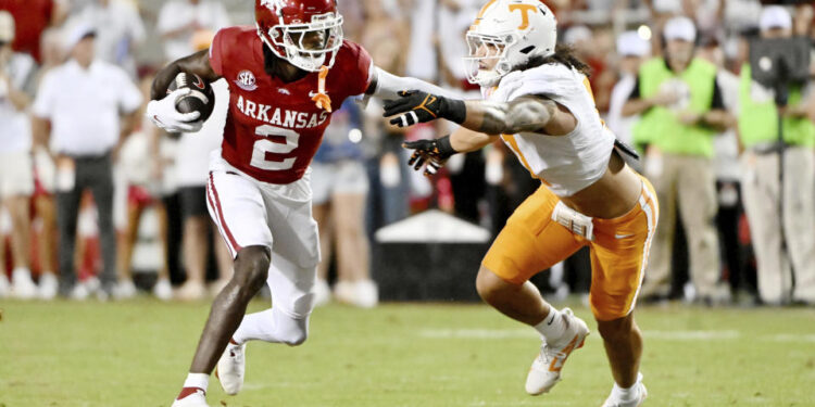 Arkansas wide receiver Andrew Armstrong (2) tries to get past Tennessee linebacker Keenan Pili (11) during the first half of an NCAA college football game, Saturday, Oct. 5, 2024, in Fayetteville, Ark. (AP Photo/Michael Woods)