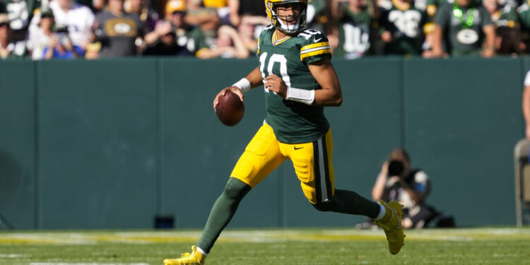 Sep 29, 2024; Green Bay, Wisconsin, USA;  Green Bay Packers quarterback Jordan Love (10) looks to throw a pass during the fourth quarter against the Minnesota Vikings at Lambeau Field. Mandatory Credit: Jeff Hanisch-Imagn Images