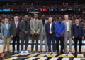 GLENDALE, ARIZONA - APRIL 06: (L-R) John Doleva, Jerry Colangelo, Chauncey Billups, Vince Carter, Michael Cooper, Bo Ryan, Charles Smith, Doug Collins and Herb Simon pose for photos during a ceremony honoring the Naismith Basketball Hall Of Fame Class Of 2024 at halftime of the NCAA Men's Basketball Tournament Final Four semifinal game between the North Carolina State Wolfpack and the Purdue Boilermakers at State Farm Stadium on April 06, 2024 in Glendale, Arizona. (Photo by Christian Petersen/Getty Images)