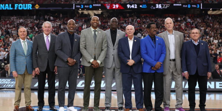 GLENDALE, ARIZONA - APRIL 06: (L-R) John Doleva, Jerry Colangelo, Chauncey Billups, Vince Carter, Michael Cooper, Bo Ryan, Charles Smith, Doug Collins and Herb Simon pose for photos during a ceremony honoring the Naismith Basketball Hall Of Fame Class Of 2024 at halftime of the NCAA Men's Basketball Tournament Final Four semifinal game between the North Carolina State Wolfpack and the Purdue Boilermakers at State Farm Stadium on April 06, 2024 in Glendale, Arizona. (Photo by Christian Petersen/Getty Images)