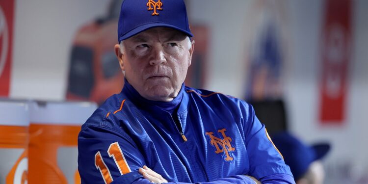 Buck Showalter looks on