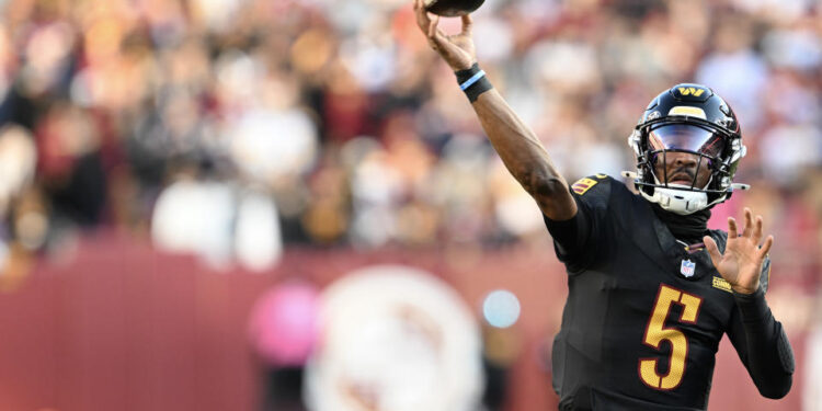 Jayden Daniels completed a Hail Mary with no time left to beat the Chicago Bears. (Photo by Greg Fiume/Getty Images)