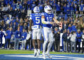 BYU wide receiver Darius Lassiter (5) and quarterback Jake Retzlaff (12) celebrate after Retzlaff ran for a touchdown in the first half of an NCAA college football game against Oklahoma State, Friday, Oct. 18, 2024, in Provo, Utah. (AP Photo/Spenser Heaps)