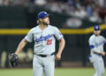 Los Angeles Dodgers pitcher Clayton Kershaw watches the flight of a fly ball during the first inning of a baseball game against the Arizona Diamondbacks Friday, Aug. 30, 2024, in Phoenix. (AP Photo/Ross D. Franklin)