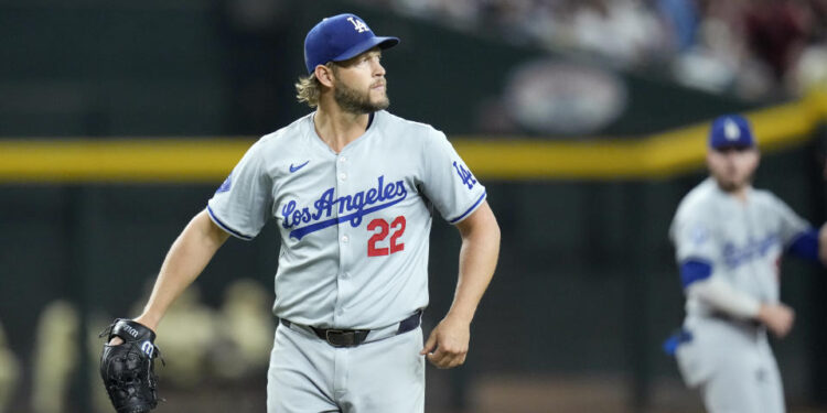 Los Angeles Dodgers pitcher Clayton Kershaw watches the flight of a fly ball during the first inning of a baseball game against the Arizona Diamondbacks Friday, Aug. 30, 2024, in Phoenix. (AP Photo/Ross D. Franklin)