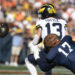 CHAMPAIGN, IL - OCTOBER 19: Michigan Wolverines Quarterback Jack Tuttle (13) fumbles the ball during the college football game between the Michigan Wolverines and the Illinois Fighting Illini on October 19, 2024, at Memorial Stadium, in Champaign, Illinois. (Photo by Michael Allio/Icon Sportswire via Getty Images)