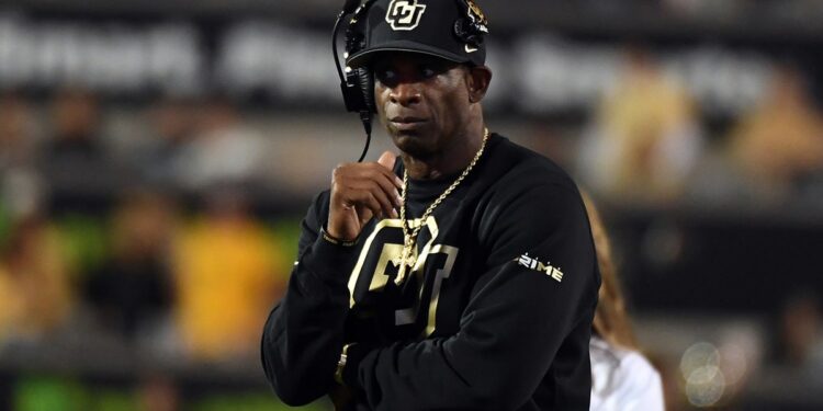 Deion Sanders looks on