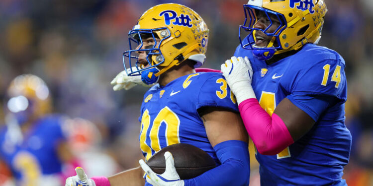 PITTSBURGH, PA - OCTOBER 24: Pittsburgh Panthers linebacker Brandon George (30) and Pittsburgh Panthers defensive lineman Chief Borders (14) celebrate after George made an interception during the first quarter of the college football game between the Syracuse Orange and Pittsburgh Panthers on October 24, 2024, at Acrisure Stadium in Pittsburgh, PA. (Photo by Frank Jansky/Icon Sportswire via Getty Images)