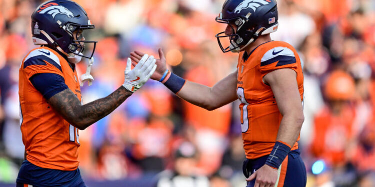 DENVER, COLORADO - OCTOBER 13:  Troy Franklin #16 and Bo Nix #10 of the Denver Broncos celebrate after a fourth quarter touchdown against the Los Angeles Chargers at Empower Field at Mile High on October 13, 2024 in Denver, Colorado. (Photo by Dustin Bradford/Getty Images)