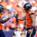 DENVER, COLORADO - OCTOBER 13:  Troy Franklin #16 and Bo Nix #10 of the Denver Broncos celebrate after a fourth quarter touchdown against the Los Angeles Chargers at Empower Field at Mile High on October 13, 2024 in Denver, Colorado. (Photo by Dustin Bradford/Getty Images)