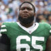 NASHVILLE, TN - SEPTEMBER 15: Xavier Newman #65 of the New York Jets looks on from the sideline during the national anthem prior to an NFL football game against the Tennessee Titans at Nissan Stadium on September 15, 2024 in Nashville, TN. (Photo by Perry Knotts/Getty Images)