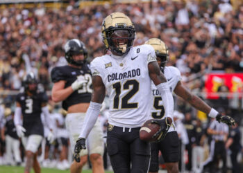 Sep 28, 2024; Orlando, Florida, USA; Colorado Buffaloes wide receiver Travis Hunter (12) scores a touchdown against the UCF Knights during the first quarter at FBC Mortgage Stadium. Mandatory Credit: Mike Watters-Imagn Images