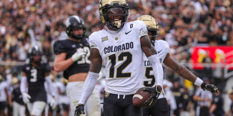 Sep 28, 2024; Orlando, Florida, USA; Colorado Buffaloes wide receiver Travis Hunter (12) scores a touchdown against the UCF Knights during the first quarter at FBC Mortgage Stadium. Mandatory Credit: Mike Watters-Imagn Images