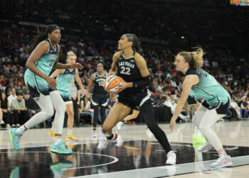 LAS VEGAS, NEVADA - OCTOBER 04: A'ja Wilson #22 of the Las Vegas Aces drives to the basket against Jonquel Jones #35 and Sabrina Ionescu #20 of the New York Liberty in the second quarter of Game Three of the 2024 WNBA Playoffs semifinals at Michelob ULTRA Arena on October 04, 2024 in Las Vegas, Nevada. The Aces defeated the Liberty 95-81. NOTE TO USER: User expressly acknowledges and agrees that, by downloading and or using this photograph, User is consenting to the terms and conditions of the Getty Images License Agreement. (Photo by Ethan Miller/Getty Images)